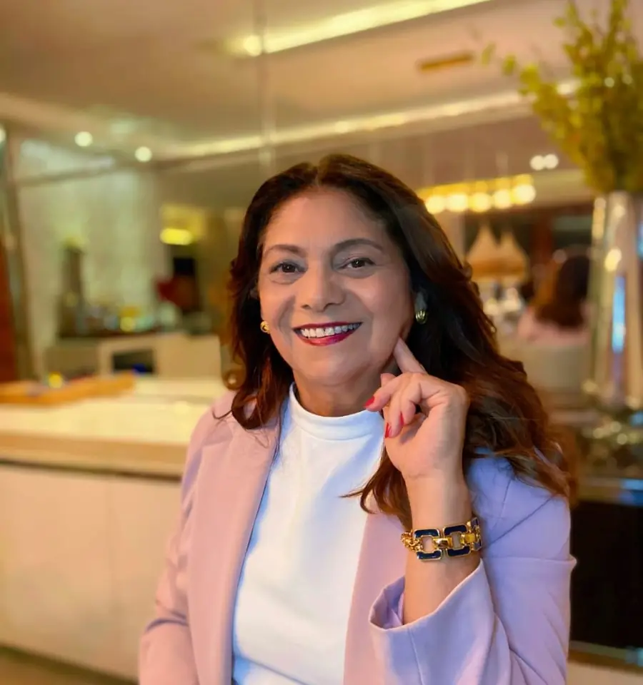Retrato de Luci Martins sorrindo, de blazer rosa